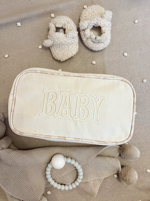 Large canvas travel bag for babies, angled view showcasing spacious design and stylish features.