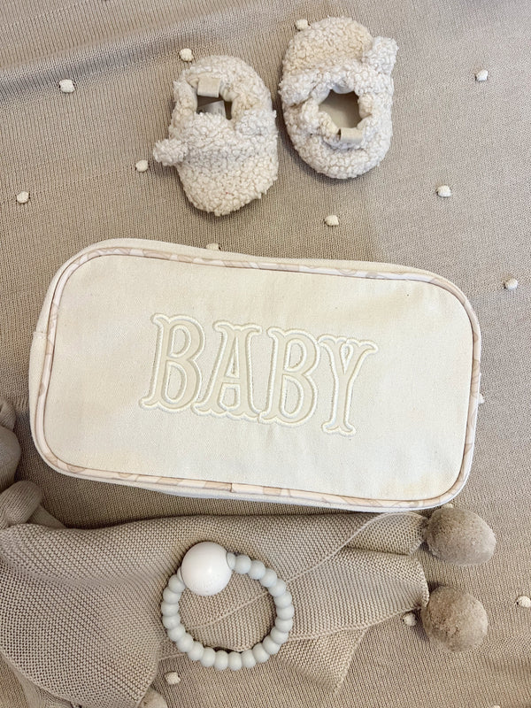 Large canvas travel bag for babies, angled view showcasing spacious design and stylish features.