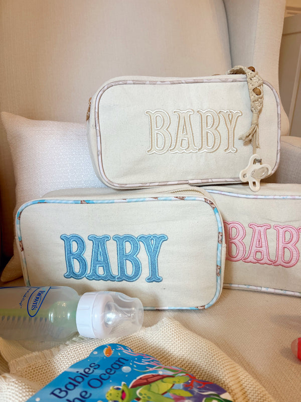 Large canvas travel bag for babies, angled view showcasing spacious design and stylish features.