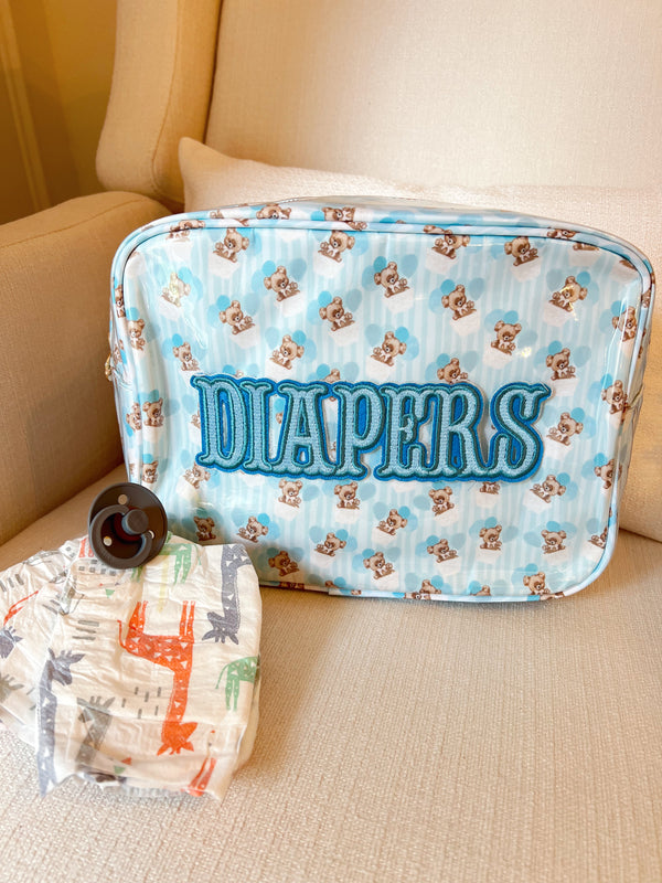 XL Diapers in a clear coat travel bag, angled view showcasing convenience and portability for parents on the go.