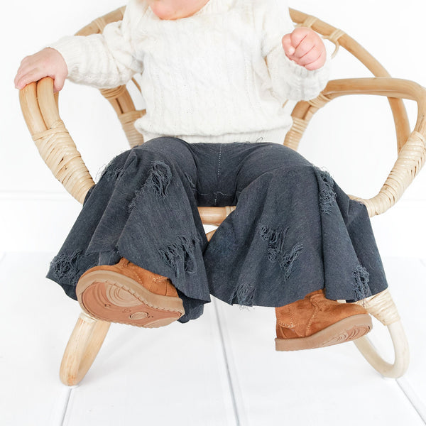 Distressed denim baby bell bottoms, stylish and comfy, perfect for little ones. Angle 3 view showcasing design details.