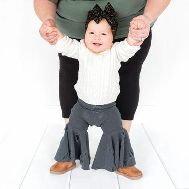Distressed denim baby bell bottoms for stylish little ones, perfect for casual outfits and playtime.