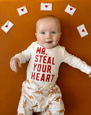 Valentine's Day Mr. Steal Your Heart Dino Jogger Outfit for babies, two-piece set, playful design, angle view.