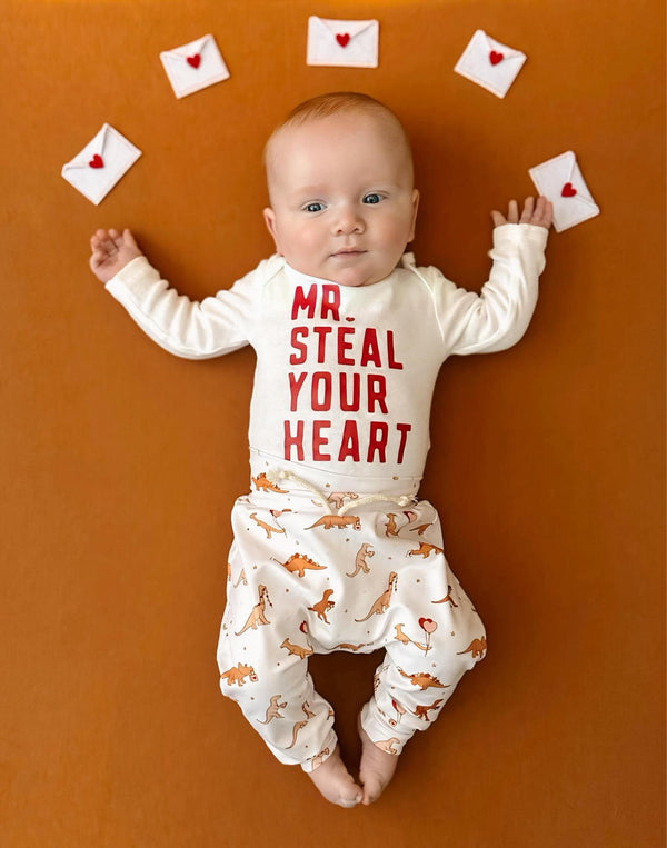 Valentine's Day Mr. Steal Your Heart Dino Jogger Outfit for babies, two-piece set, playful design, angle view.