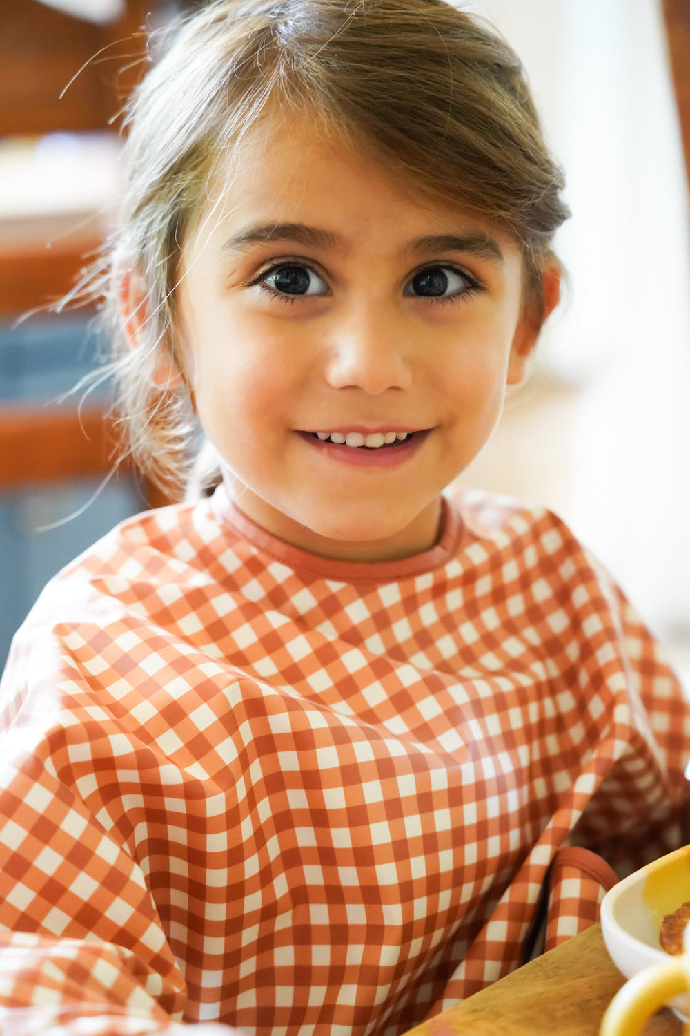 Sienna Gingham Smock Bib for babies, stylish and practical for mealtime messes.
