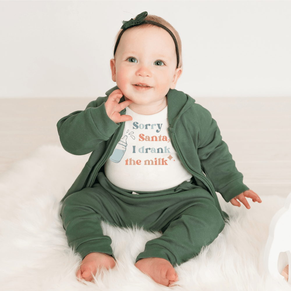 Short sleeve graphic bodysuit for babies featuring "Drank the Milk" design. Perfect for playful outfits.