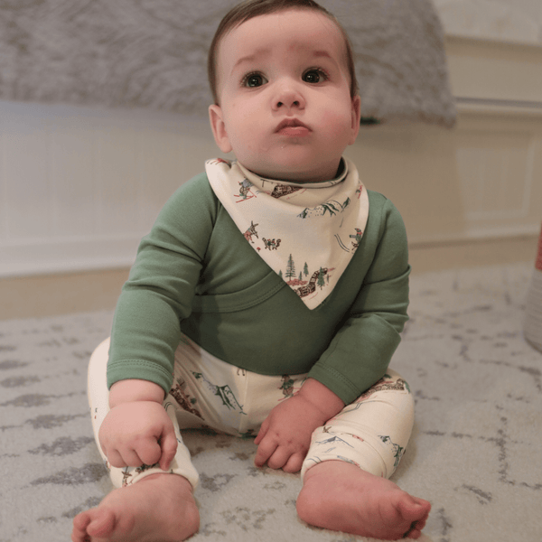 Basil Green long sleeve bodysuit for babies, angle view showcasing soft fabric and stylish design.
