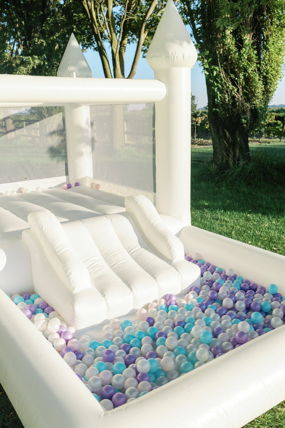 Mini Marcos White COMBO Bounce House with Ball Pit for outdoor play, perfect for babies and toddlers.