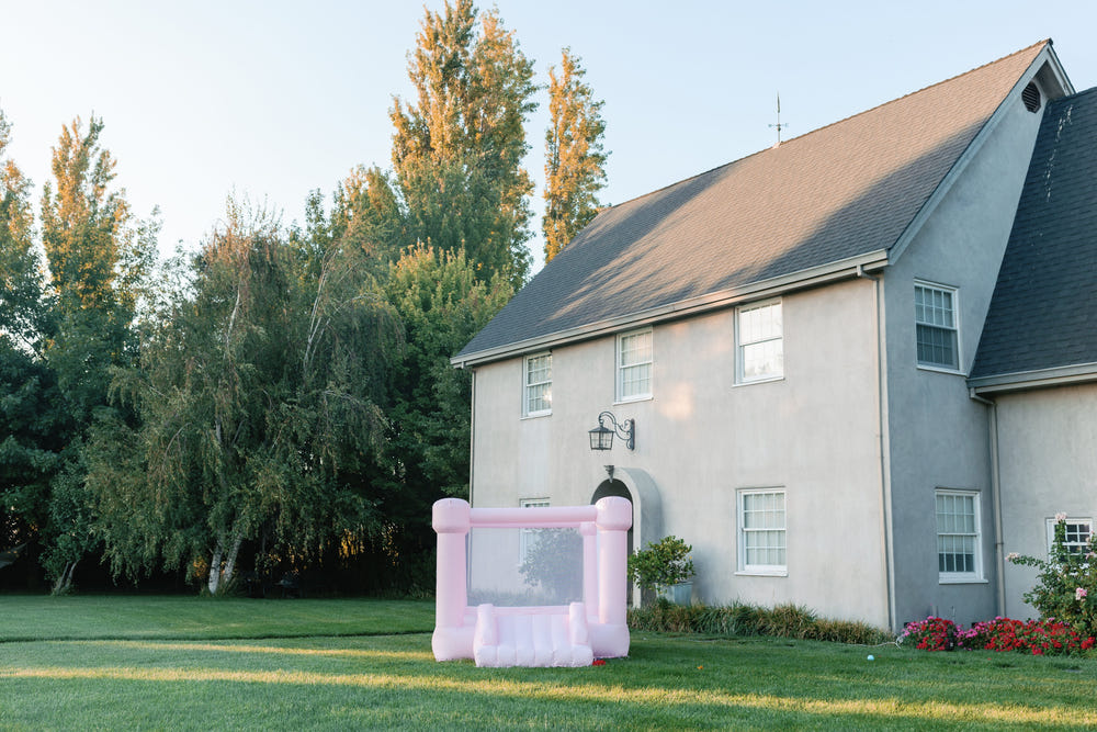 Mini Mila pastel pink bounce house for outdoor playsets, perfect for fun and active playtime for toddlers.