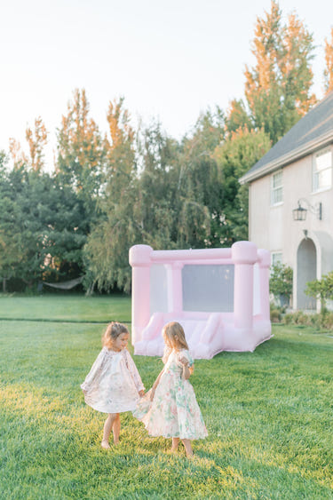 Mini Mila pastel pink bounce house for outdoor playsets, perfect for fun and active playtime for toddlers.