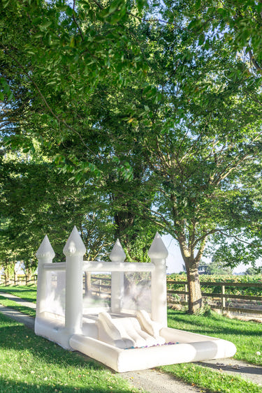 Mini Marcos White COMBO Bounce House with Ball Pit for outdoor play, perfect for babies and toddlers.