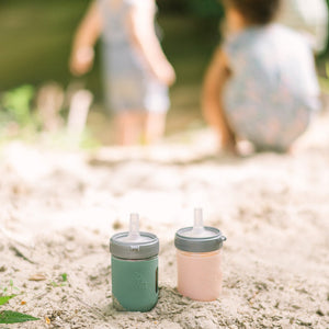 Silicone sleeve 2 pack for baby cups, providing grip and protection, angle view showcasing vibrant colors and design.