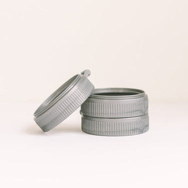 Three colorful plastic rings for baby bottles, essential accessories for feeding convenience and safety.