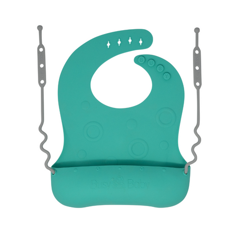 Travel Tether Bib in soft silicone, perfect for mess-free feeding on the go.