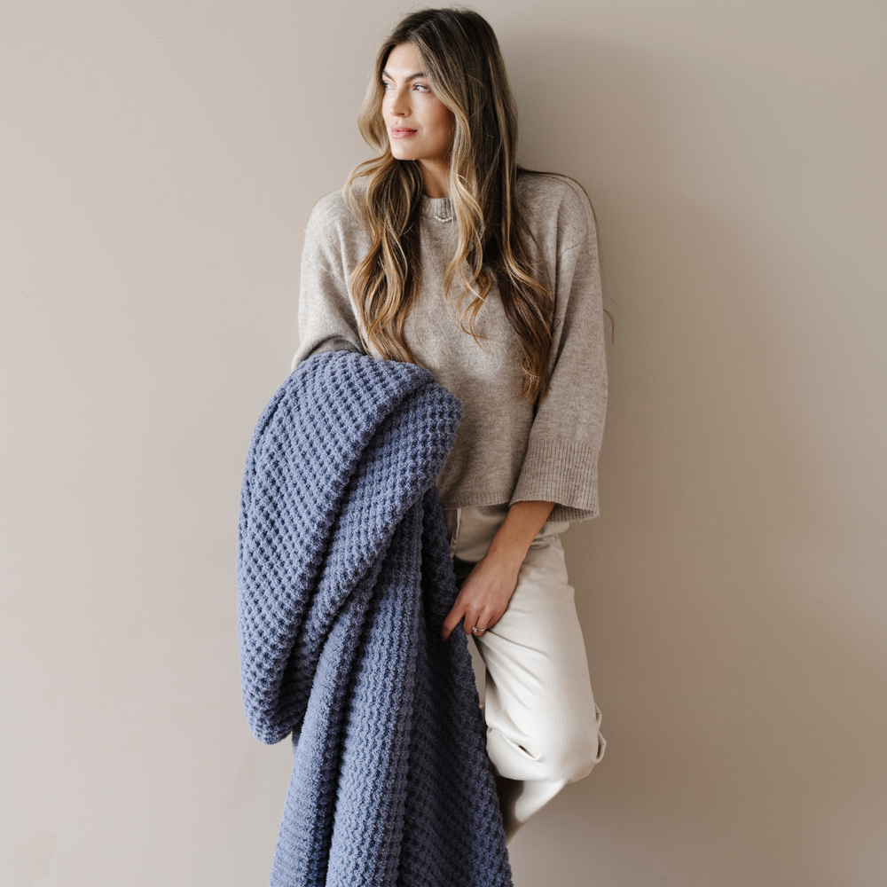 Soft waffle knit throw blanket for babies, perfect for cozy swaddling and comfort. Ideal for nurseries and playtime.