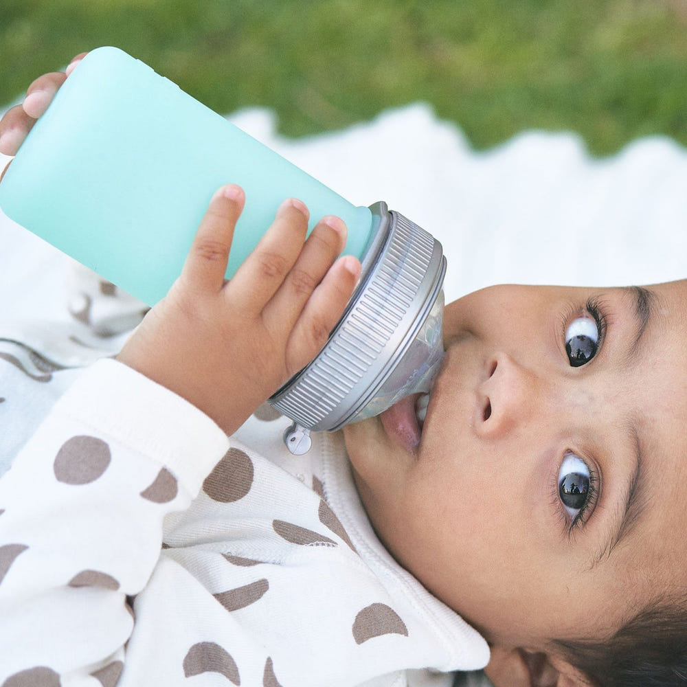 Silicone baby bottle in soft colors, perfect for safe feeding and easy grip for little hands.