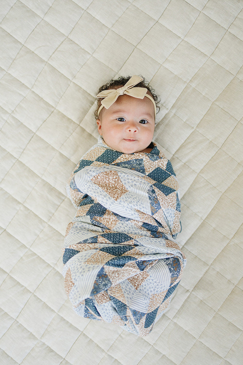 Patchwork print muslin swaddle blanket for babies, soft and breathable for comfort and style.