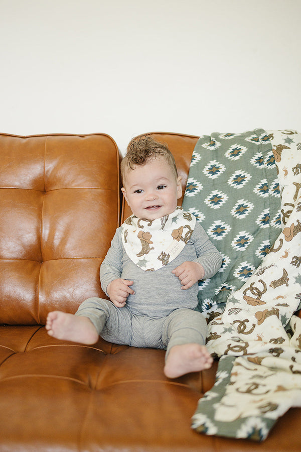 Outlaw Cowboy Classic Muslin Bib for babies, showcasing a stylish design from angle 2. Perfect for mealtime messes.