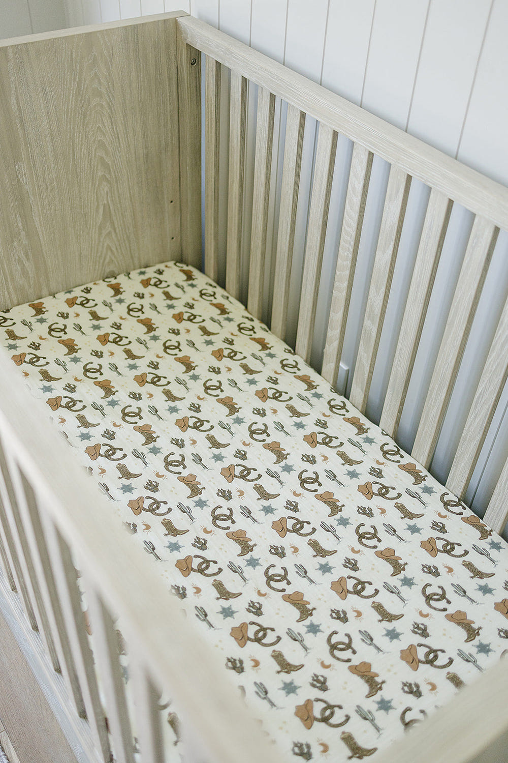 Outlaw Cowboy Muslin Crib Sheet for stylish and comfortable baby bedding and sleep.
