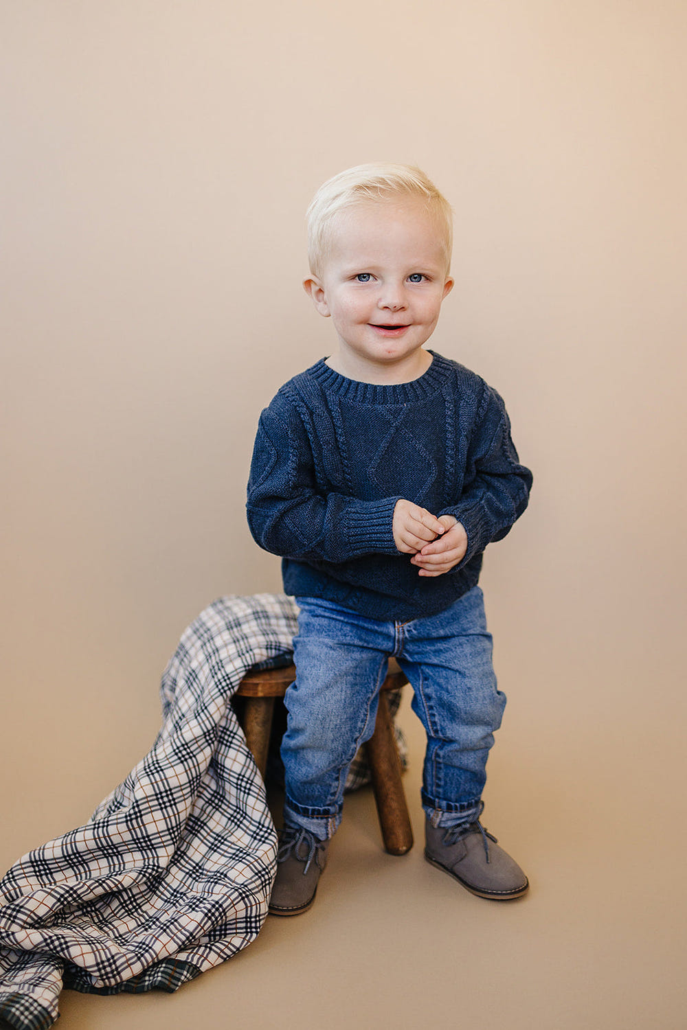 Navy cable knit sweater for babies, cozy and stylish clothing for infants.