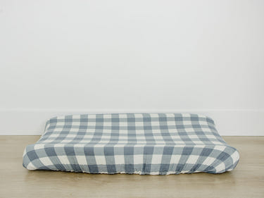 Dusty blue gingham muslin changing pad cover for stylish and comfortable diaper changes.
