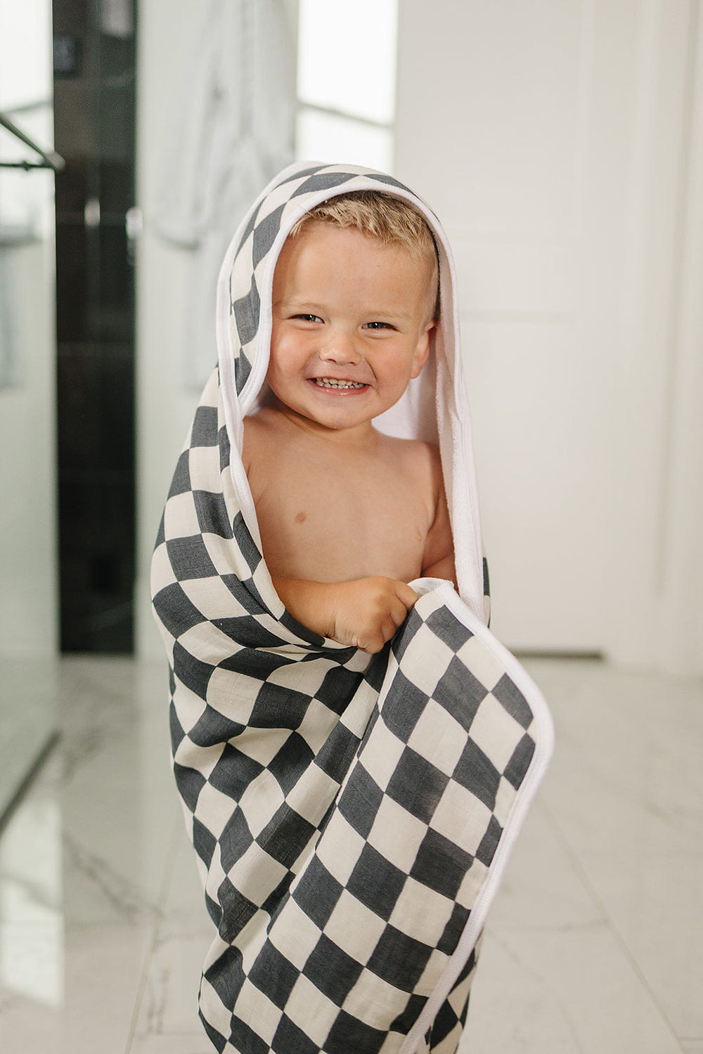 Charcoal checkered muslin hooded towel for babies, soft and stylish for bath time.