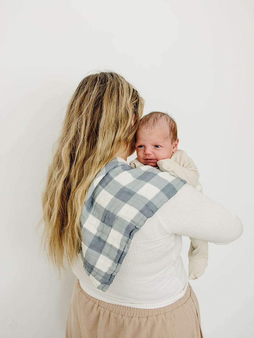Dusty blue gingham muslin burp cloth for babies, soft and stylish, perfect for feeding and drooling.
