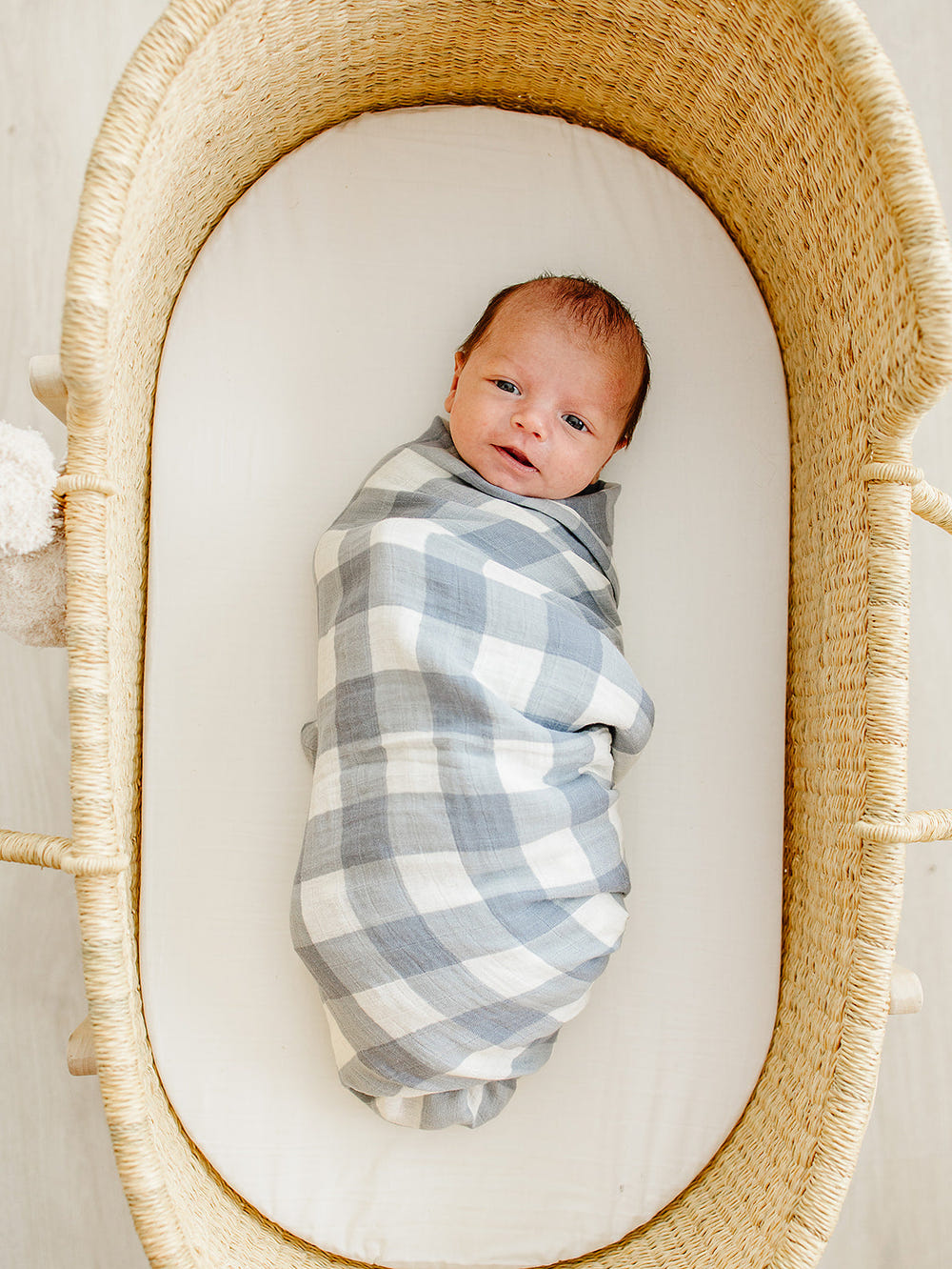 Dusty blue gingham muslin swaddle blanket for babies, perfect for cozy and stylish swaddling.