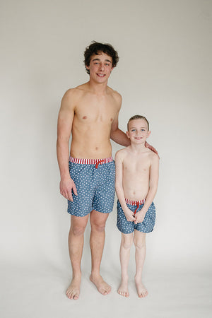 Men's Stars and Stripes swim shorts, angle view, perfect for summer beach outings and poolside fun.