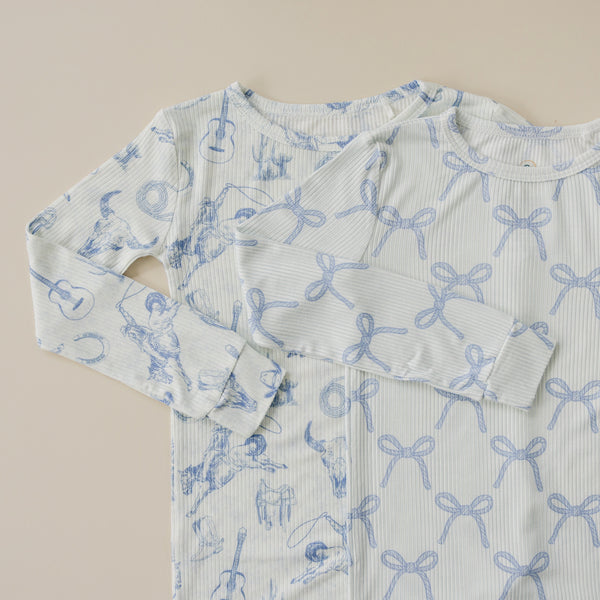 Blue Belle Ribbed Bamboo Zippy Pajamas for babies, shown from angle 3, soft and stylish sleepwear.