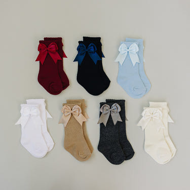 Mebie High Rise Bow Socks for babies in soft fabric, featuring a cute bow design, perfect for stylish little ones.