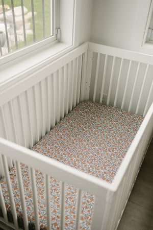 Dainty Meadow Bamboo Stretch Crib Sheet in soft fabric, showcasing floral design from angle 3 for nursery decor.
