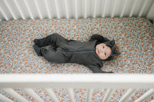 Dainty Meadow Bamboo Stretch Crib Sheet in soft pastel colors, perfect for a cozy nursery bedding setup.