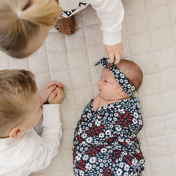Americana Floral Ribbed Bamboo Stretch Swaddle in angle view, perfect for cozy and stylish baby wrapping.
