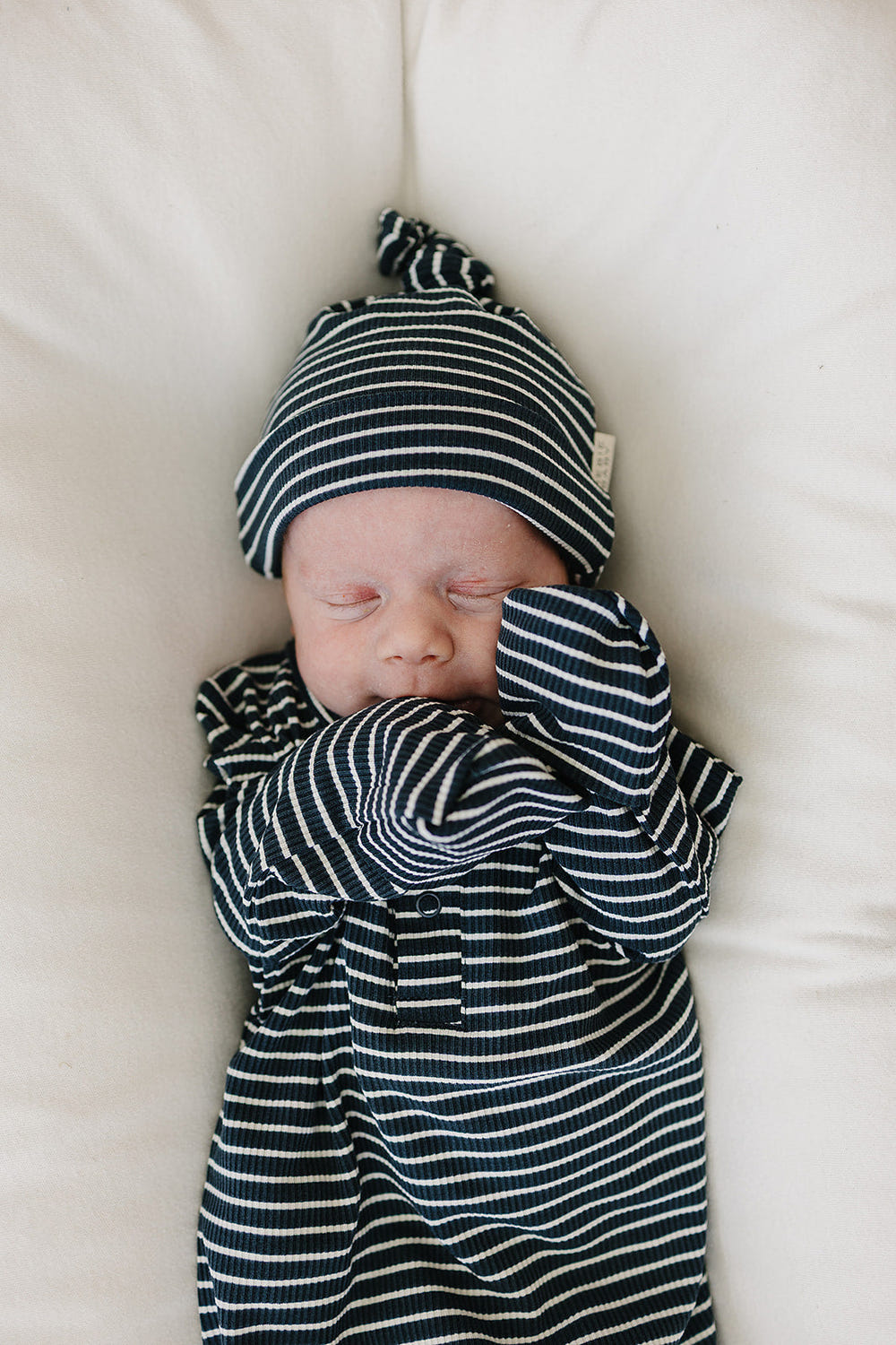 Navy stripes ribbed bamboo newborn knot hat for comfortable sleep and stylish bedding.