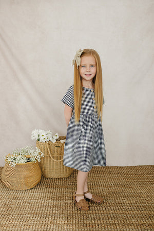 Navy gingham linen cotton dress for babies, showcasing a stylish design from angle 2. Perfect for any occasion.