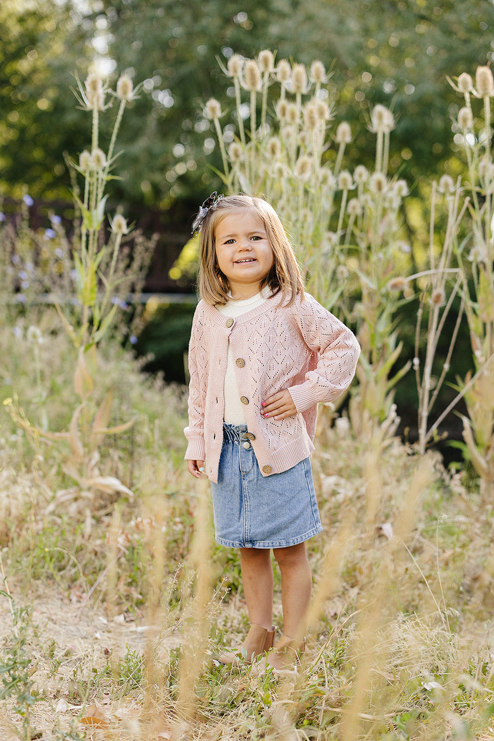Pink pointelle button down cardigan for babies, soft and stylish clothing for little ones.