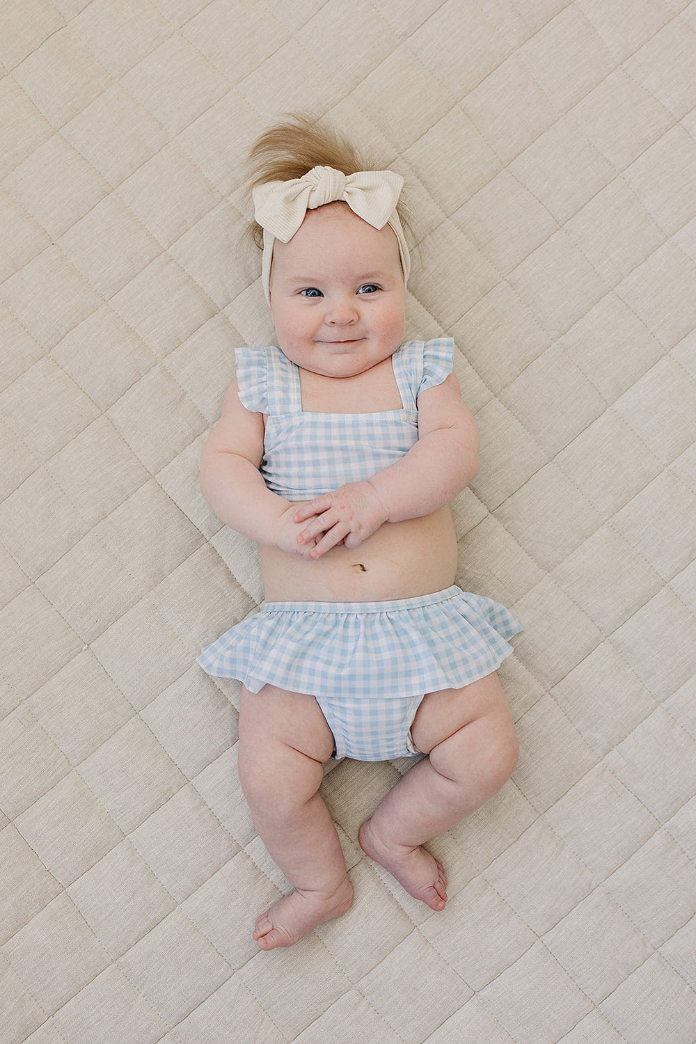 Light blue gingham ruffle bikini set for babies, perfect for summer fun and nursery decor.
