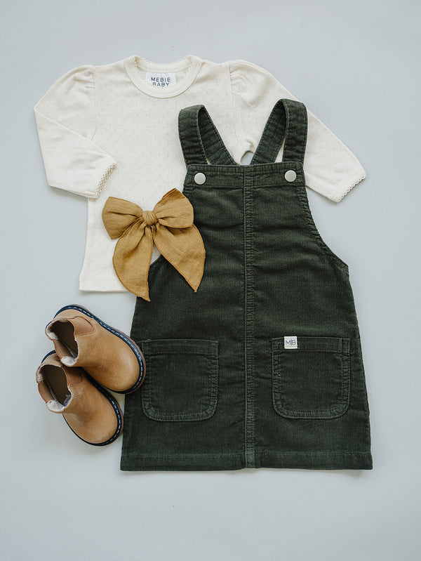 Green corduroy dress for babies, stylish and cozy, shown at angle 8 for a detailed view.