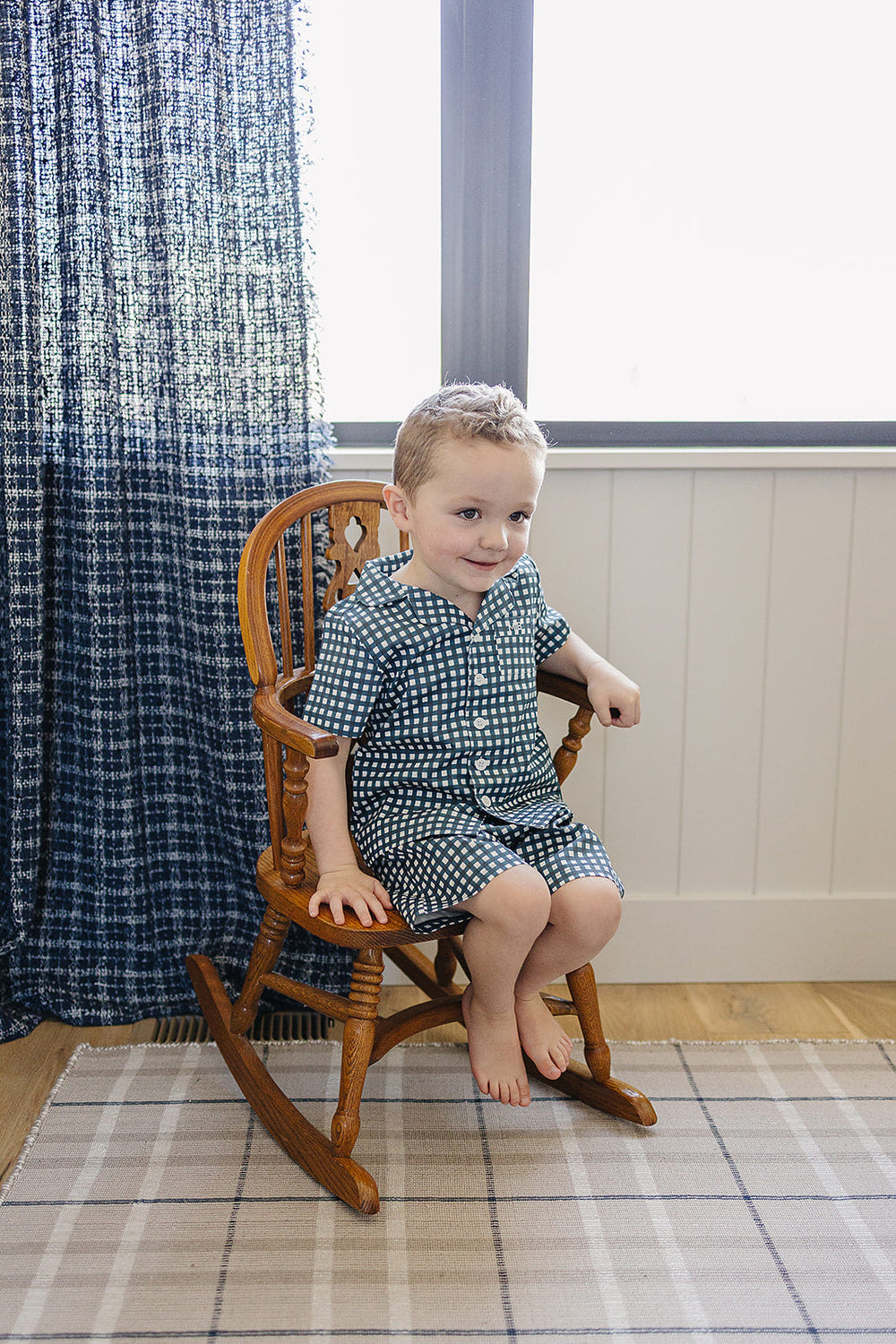 Navy gingham short pajama set for babies, perfect for comfortable sleep and stylish bedding.