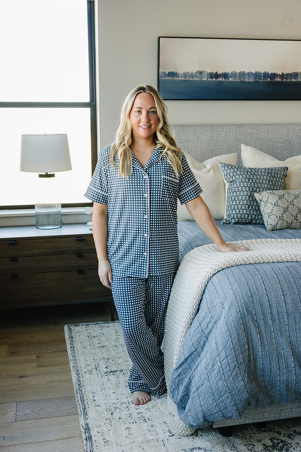Women's navy gingham pajama set for babies, perfect for cozy sleep and stylish bedding.