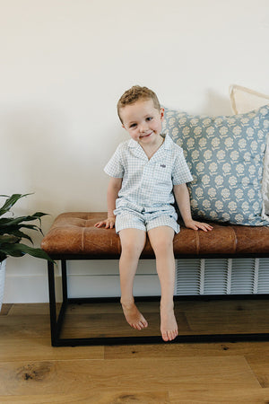 Light blue gingham short pajama set for babies, perfect for comfortable sleep and cozy nights.