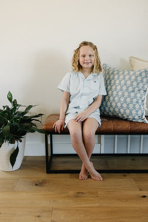 Light blue gingham short pajama set for babies, perfect for comfortable sleep and cozy nights.