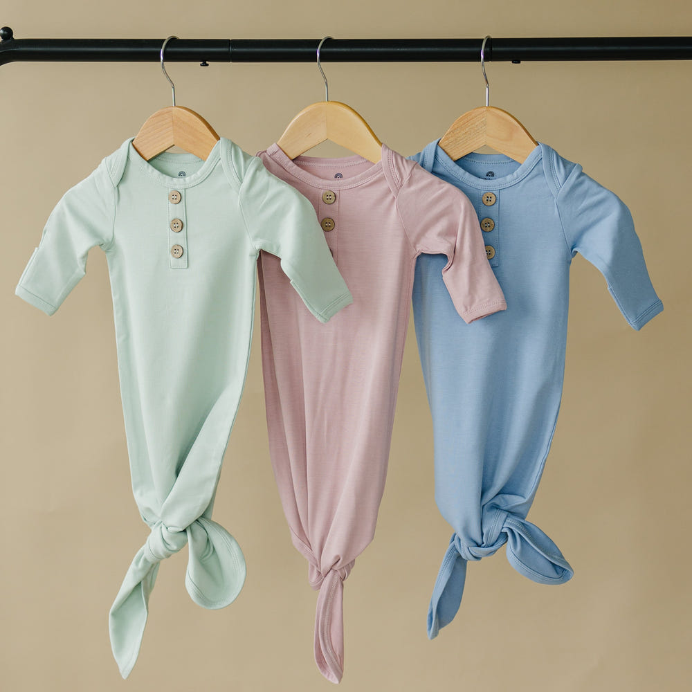 Newborn bamboo gown and hat set, soft and breathable, perfect for swaddling and comfort.