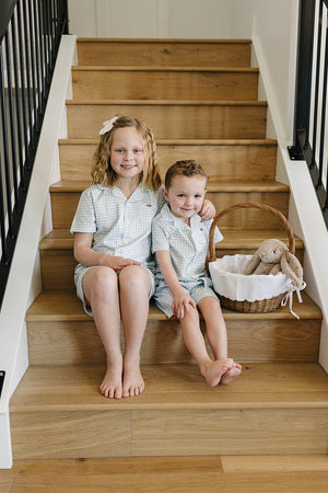 Light blue gingham short pajama set for babies, perfect for comfortable sleep and stylish bedding.