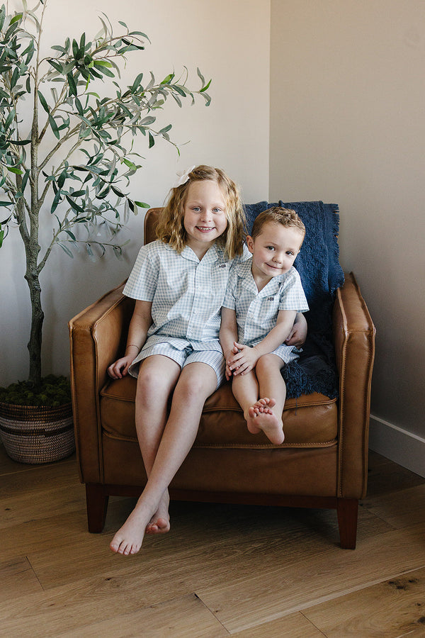 Light blue gingham short pajama set for babies, perfect for comfortable sleep and stylish bedding.
