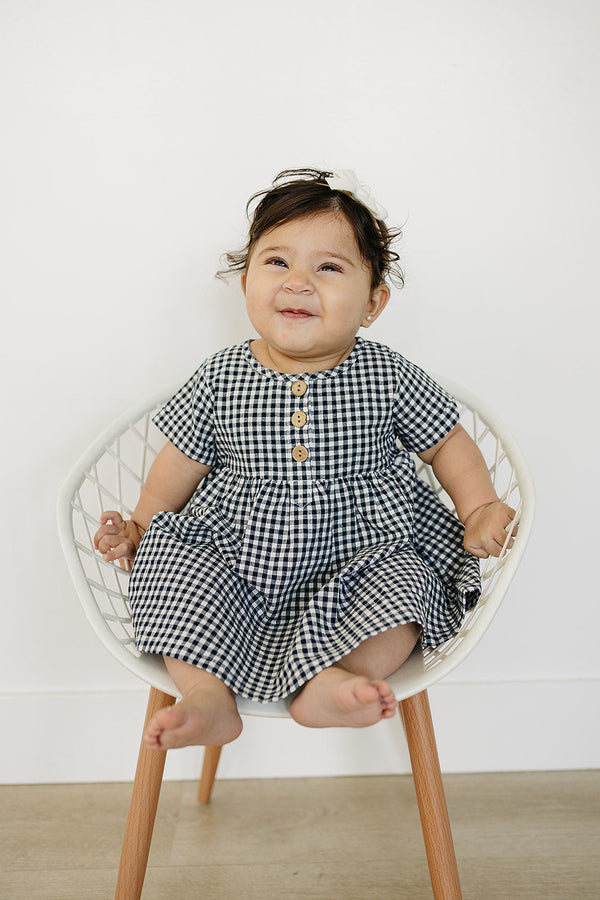 Navy gingham linen cotton dress for babies, stylish and comfortable, shown from angle 3.