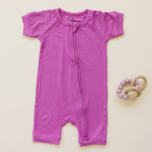 Solid ribbed bamboo shorty romper in various colors, angle view showcasing soft fabric and stylish design for babies.