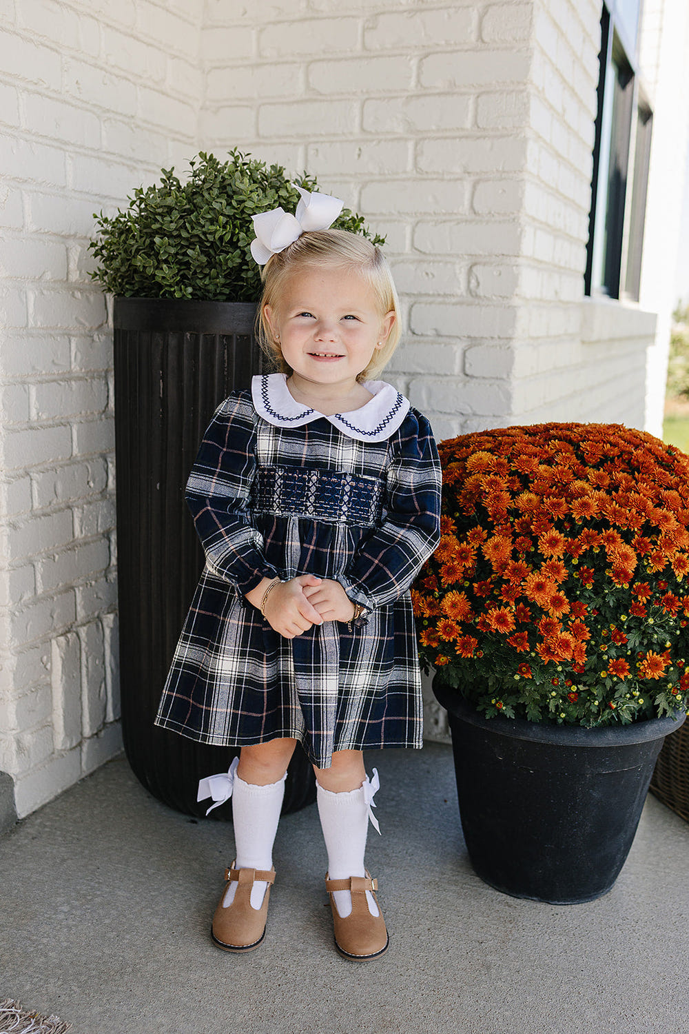 Navy plaid smocked dress for babies, perfect for stylish and comfortable wear.