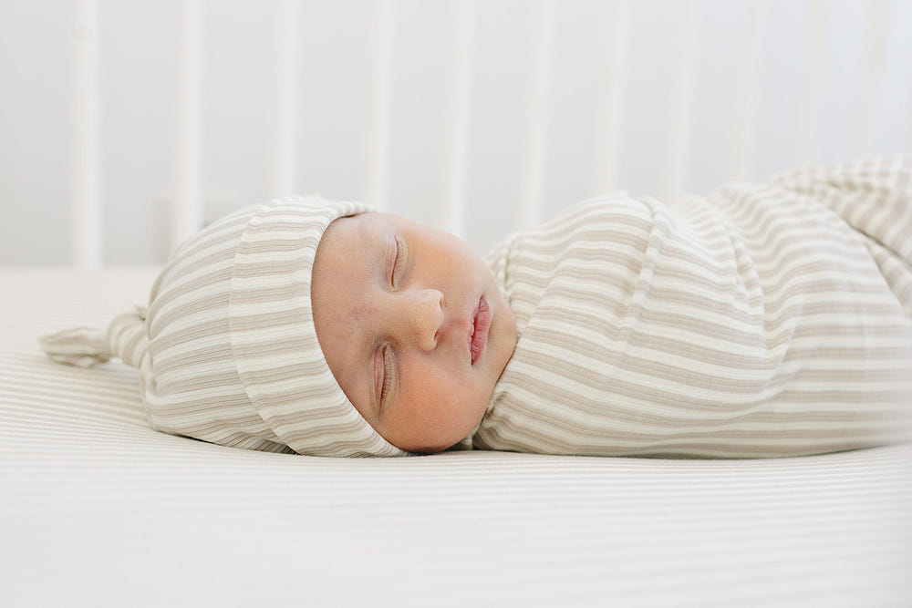 Taupe stripe ribbed bamboo newborn knot hat for stylish and comfortable baby wear.